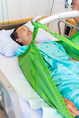 Image showing Patient Lying On Sling Of Hydraulic Lift On Hospital Bed