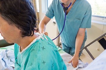 Image showing Nurse Examining Patient's Back With Stethoscope
