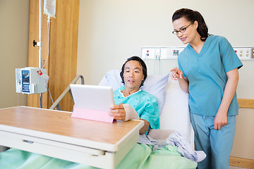 Image showing Patient Using Digital Tablet While Nurse Pointing At It