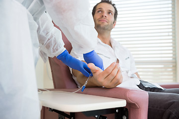 Image showing Patient Looking At Nurse While Receiving Intravenous Treatment I