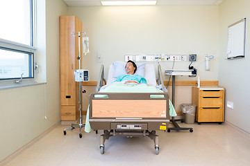 Image showing Patient Lying On Bed While Looking At Window In Hospital