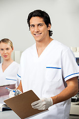 Image showing Male Researcher Holding Clipboard In Lab