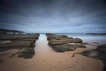 Image showing Stormy beach with natural rock channel Soldiers Beach point