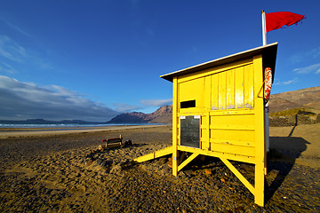 Image showing water lifeguard chair cabin red flag   rock stone sky