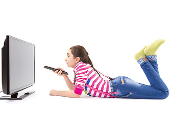 Image showing Happy little girl with remote control watching tv
