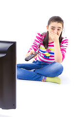 Image showing Scared  little girl watching tv