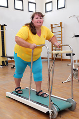 Image showing overweight woman running on trainer treadmill