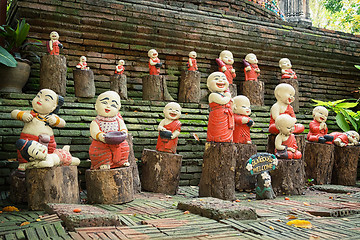 Image showing Funny little concrete statues at the walls of the ancient temple