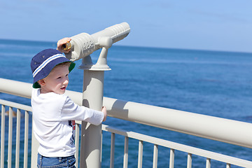 Image showing boy using seaside binoculars