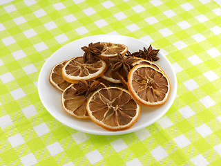 Image showing old lemon slices and cinnamon on white plate