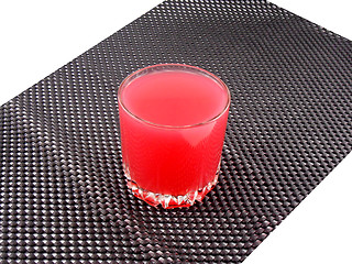 Image showing fresh cherry juice in a glass on black background