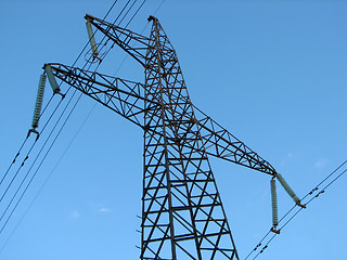 Image showing Powerline tower seen from below against blue sky