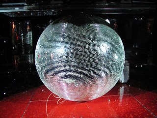 Image showing Huge mirror sphere under the board of DJ in a night club