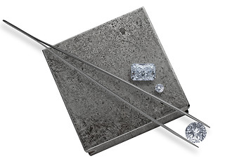 Image showing diamonds and tweezers on a jeweler anvil