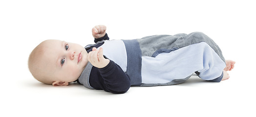 Image showing smiling toddler laying on his back