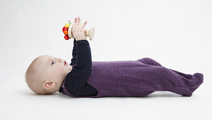 Image showing baby lying on his back with toy