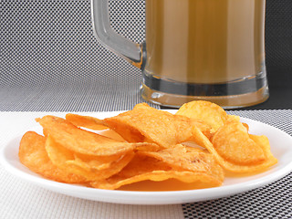 Image showing Mug of Fresh Beer and plate with Pile potato chips