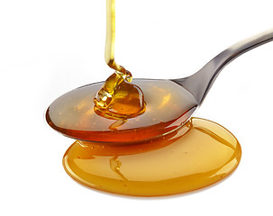 Image showing honey pouring into spoon