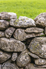 Image showing Fence made of rough stones covered by moss