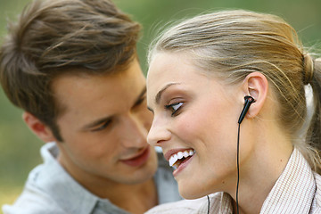 Image showing beautiful couple listening player 