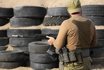 Image showing  Shooter with a Kalashnikov assault rifle