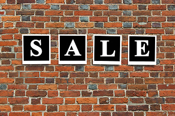 Image showing inscription sale on the red brick wall