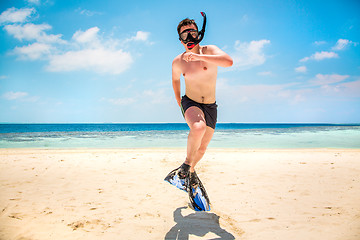 Image showing Funny man jumping in flippers and mask.