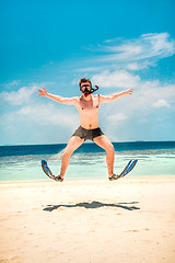Image showing Funny man jumping in flippers and mask.