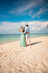 Image showing Vacation Couple walking on tropical beach Maldives.