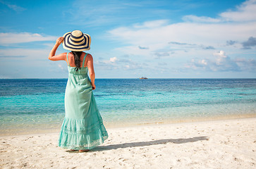 Image showing Girl walking along a tropical beach in the Maldives.