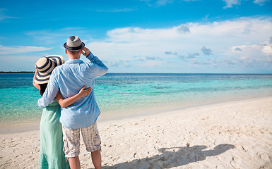 Image showing Vacation Couple walking on tropical beach Maldives.