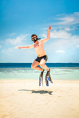 Image showing Funny man jumping in flippers and mask.