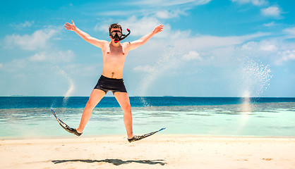 Image showing Funny man jumping in flippers and mask.