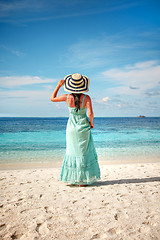 Image showing Girl walking along a tropical beach in the Maldives.