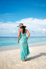 Image showing Girl walking along a tropical beach in the Maldives.