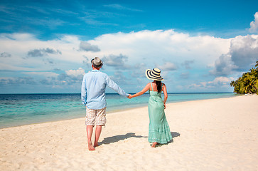 Image showing Vacation Couple walking on tropical beach Maldives.