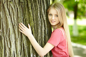 Image showing Female hugging a tree