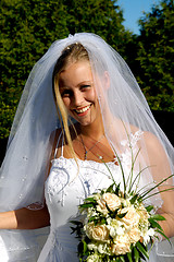 Image showing Happy smiling wedding bride with bouquet.