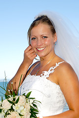 Image showing Happy smiling wedding bride with bouquet.