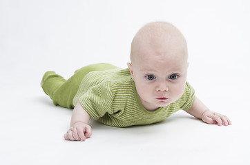 Image showing pensive toddler in green clothing