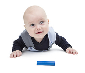 Image showing interested baby with toy block