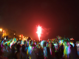 Image showing Fireworks over the crowd of people dancing on the beach