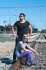 Image showing Two guys on train tracks
