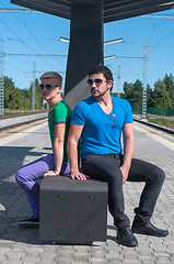 Image showing Handsome guys sitting on platform