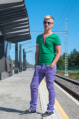 Image showing Stylish man with sun glasses standing on platform