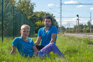 Image showing Two guys sitting in a grass