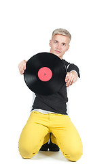 Image showing Young man showing from vinyl record