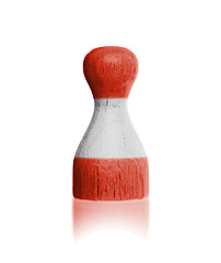 Image showing Wooden pawn with a painting of a flag