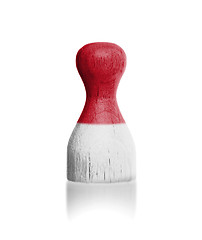 Image showing Wooden pawn with a painting of a flag