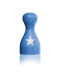 Image showing Wooden pawn with a painting of a flag